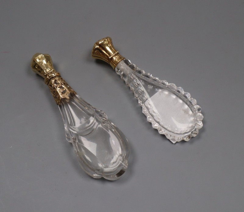 Two 19th century French yellow metal mounted cut glass scent bottles, largest 12.2cm, both lacking stoppers?.